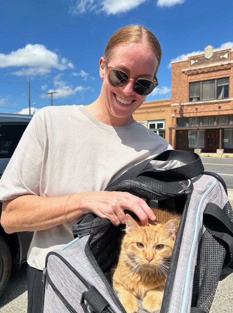 Fuzz orange tabby kitten gets adopted by red head in Austin